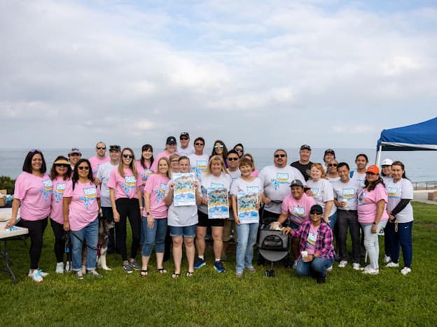 Group of people with Coastal Cleanup shirts and flyers