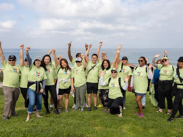 Group of people waving at the camera